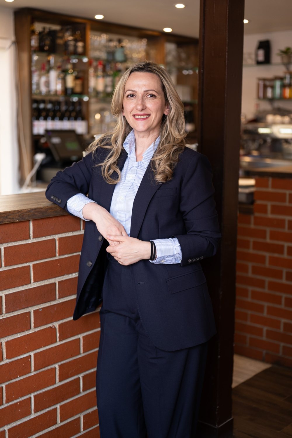 Ardita Kurtaj, founder of Mio Fiore, smiling in one of her restaurants.
